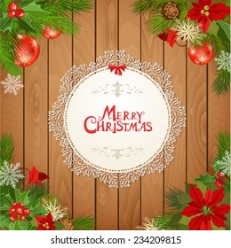 Christmas card with pine twigs and holly berry and poinsettia on wooden background