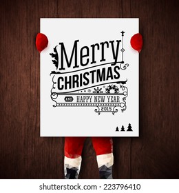 Christmas card. Santa is holding a poster with holiday greetings. Vector illustration.