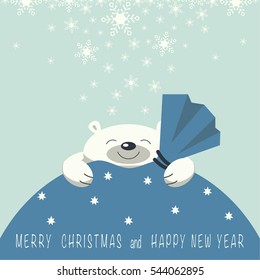 Christmas card. The smiling polar bear is on the gift bag. Gift bag is blue. On the gift bag the phrase merry Christmas and a happy New year.