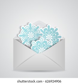 Christmas card with snowflake inside open envelope in white background