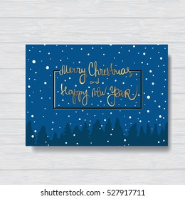 Christmas card.
 Spruce with frame and inscripton on a wooden background.