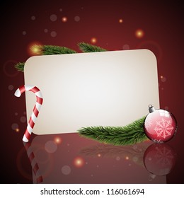Christmas card with Christmas tree branches, candy and red ornament on a red background.