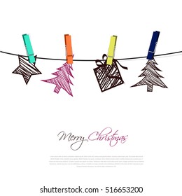 christmas card with tree, gift and star from paper stripe hanging on a line with peg 
