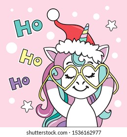 Christmas card with a unicorn in a santa claus hat and the inscription ho ho ho on a pink background