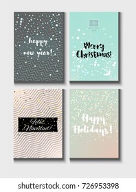 Christmas Card Vector Set with Lettering. Merry Christmas, Happy New Year, Feliz Navidad and Happy Holidays Text on Festive Background in Faded Blue, Pink, Grey and Snowfall. Tender Christmas Card Set