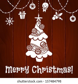 Christmas card.  Vector silhouettes of Christmas tree and Christmas symbols on wooden background. eps 10