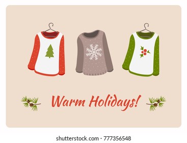 Christmas card "Warm holidays", with three trendy Christmas sweaters on 
hangers, cute and soft.