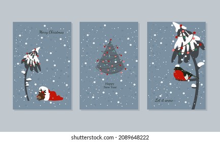 Christmas cards in light blue colours with a Christmas tree, a bullfinch on a branch and deer sleeping in a hat 