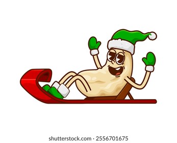 Christmas cashew nut groovy character donning green hat, boots and gloves, joyfully riding a sleigh. Cartoon vector kernel retro personage at Xmas holiday scene filled with merriment and festive cheer