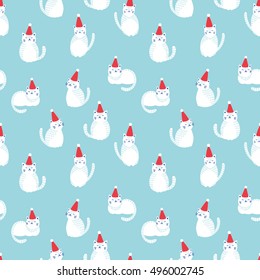 Christmas cats seamless pattern. White cute cats in red Christmas hats on blue background