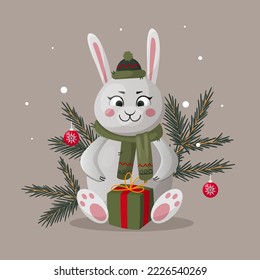 Christmas character hare in fir branches in a hat and scarf with a gift