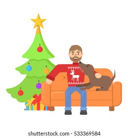 Christmas character hipster man in red sweater with deer sitting on couch with dog.