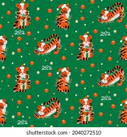 Christmas colored seamless pattern with 2022 New Years symbol. Small Tiger with garlands, christmas baubles, confetti and lettering. Flat vector illustration.