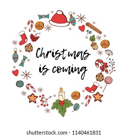 Christmas Is Coming card with festive items. Holiday frame. Greeting card for New Year and Christmas.Christmas hat, acorns, socks, candy canes, snowflakes, mistletoe and ginger cookies.