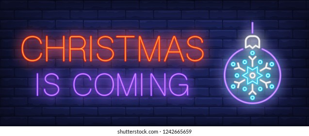 Christmas is coming neon text with bauble. Christmas advertisement design. Night bright neon sign, colorful billboard, light banner. Vector illustration in neon style.
