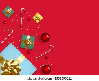 Christmas composition banner. Xmas design background with realistic gift box, glitter gold confetti, red ball decoration and candy. Top view horizontal poster with copy space. Flat lay greeting card.