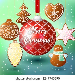 Christmas composition on a turquoise background with a big red ball and gingerbread on strings. Inscription Merry Christmas