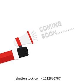Christmas concept,Hand Santa Claus holding megaphone with word Coming soon