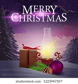 Christmas cover with purple winter landscape, gifts and antique lamp in the snow