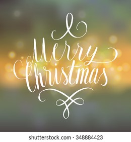 christmas curly handwriting. bokeh background.