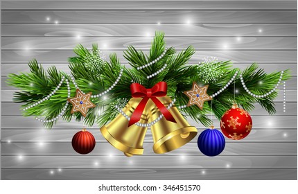 Christmas decoration  with evergreen trees and bells with balls gingerbread on wood background