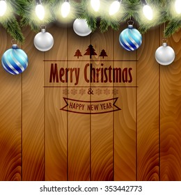 Christmas decoration on a wooden background, blue an silver Christmas ornaments.