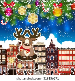 Christmas deer on the background of snow-covered streets. Green branches of Christmas trees decorated with Christmas balls and sweets. Christmas background.