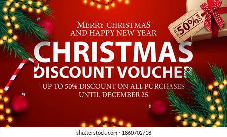 Christmas discount voucher, up to 50% off on all purchases. Red discount voucher with presents, Christmas tree branches, candy canes and Christmas balls