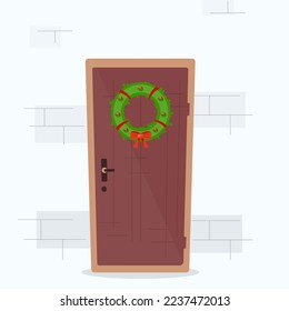 Christmas door with wreath and brick wall.