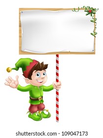 A Christmas elf or pixie or Santa's helper holding a large Christmas sign in traditional elf clothes