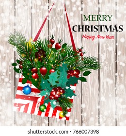 Christmas envelope with branches of spruce, red berries, Christmas decorations on a wood background. Merry Christmas. Happy new year.