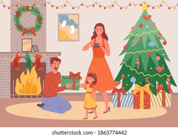 Christmas evening at home, Father gives daughter a present, happy parents and child celebrate Christmas, stay home, New Year and winter holidays