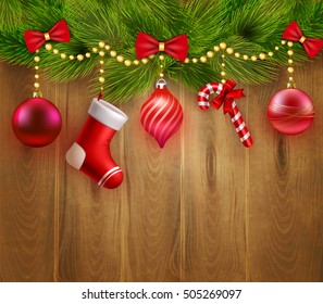 Christmas festive template with green fir twigs red balls candy sock bows on wooden background vector illustration