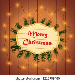 Christmas festive wooden background with fir branches and light garland