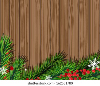 Christmas fir tree and red berries on wooden board.