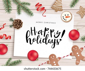 Christmas flat lay design with cookies, ribbons, Christmas ornaments, pine cones, fir branches and greeting card on wooden background