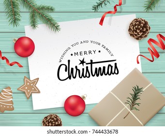 Christmas flat lay design with gift, cookies, ribbons, Christmas balls, pine cones, fir branches and greeting card on wooden background