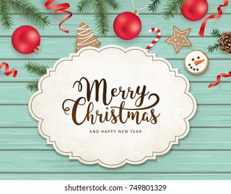 Weihnachtsflach-Design mit Bändern, Weihnachtsschmuck, Kekse, Kiefernzapfen, Tannenäste und Grußkarte auf Holzhintergrund