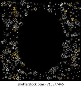 Christmas frame or border with random scatter falling silver and gold snowflakes isolated on black.