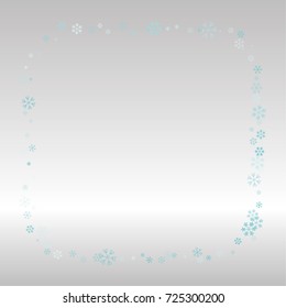 Christmas frame or border with random scatter falling blue snowflakes on a silvery background.