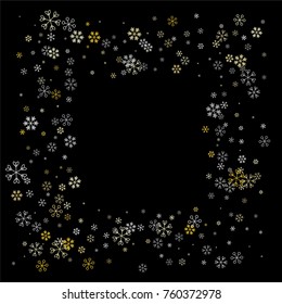 Christmas frame or border with random scatter falling silver and gold snowflakes isolated on black.