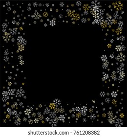 Christmas frame or border with random scatter falling silver and gold snowflakes isolated on black.
