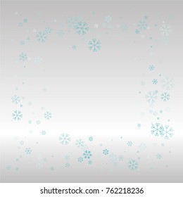 Christmas frame or border with random scatter falling blue snowflakes on a silvery background.