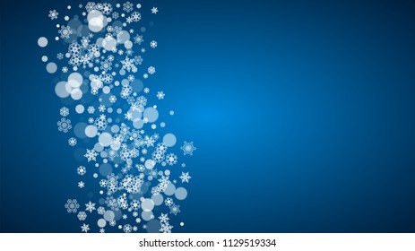 Christmas frame with falling snow on blue background. Horizontal Merry Christmas frame with white frosty snowflakes for banners, gift cards, party invitations and special business offers.