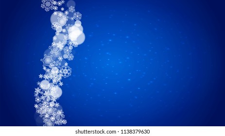 Christmas frame with falling snow on blue background with sparkles. Horizontal Christmas frame with white frosty snowflakes for banners, gift cards, party invitations and special business offers.