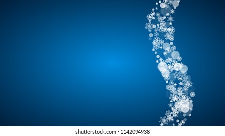 Christmas frame with falling snow on blue background. Horizontal Merry Christmas frame with white frosty snowflakes for banners, gift cards, party invitations and special business offers.