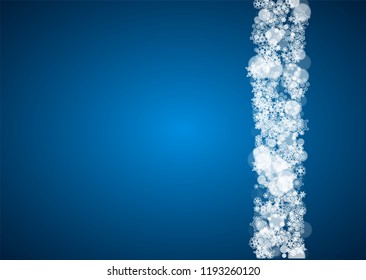 Christmas frame with falling snow on blue background. Horizontal Merry Christmas frame with white frosty snowflakes for banners, gift cards, party invitations and special business offers.