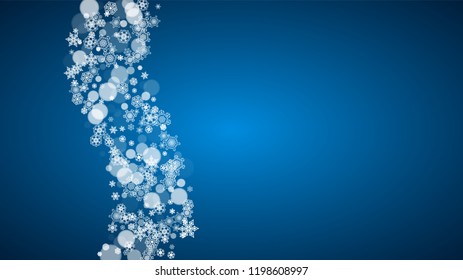 Christmas frame with falling snow on blue background. Horizontal Merry Christmas frame with white frosty snowflakes for banners, gift cards, party invitations and special business offers.