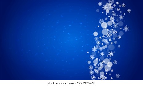 Christmas frame with falling snow on blue background with sparkles. Horizontal Christmas frame with white frosty snowflakes for banners, gift cards, party invitations and special business offers.