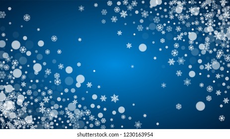 Christmas frame with falling snow on blue background. Horizontal Merry Christmas frame with white frosty snowflakes for banners, gift cards, party invitations and special business offers.